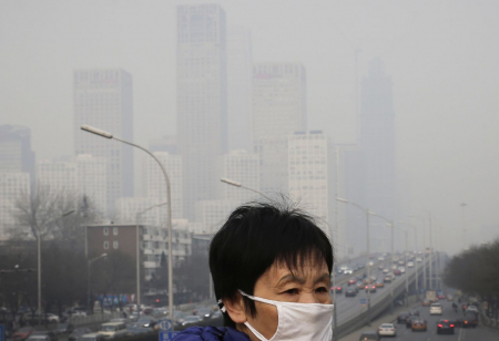 Smog in Beijing, Dezember 2015 – Fußgänger müssen zum Schutz vor der hohen Feinstaubbelastung regelmäßig Atemschutzmasken tragen.(picture alliance/AP Photo/Andy Wong)